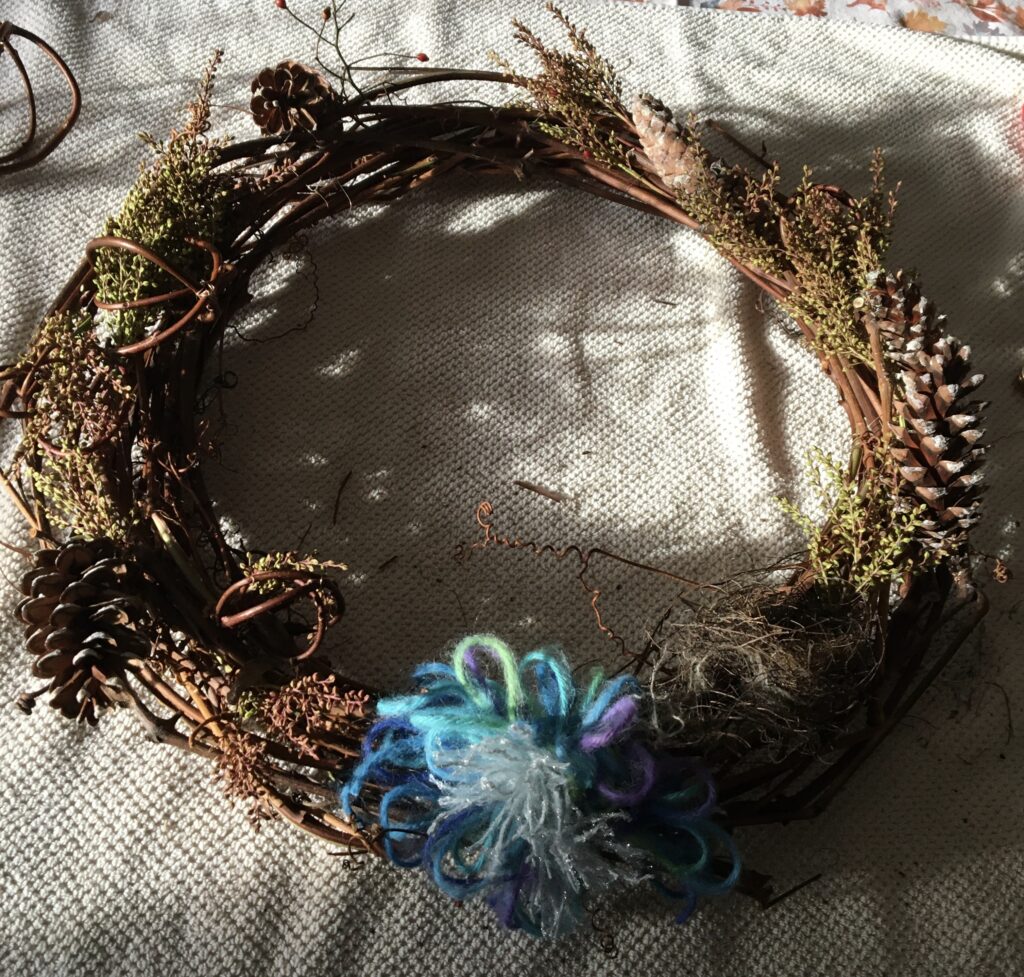 wreath decorated with natural materials and yarn bow