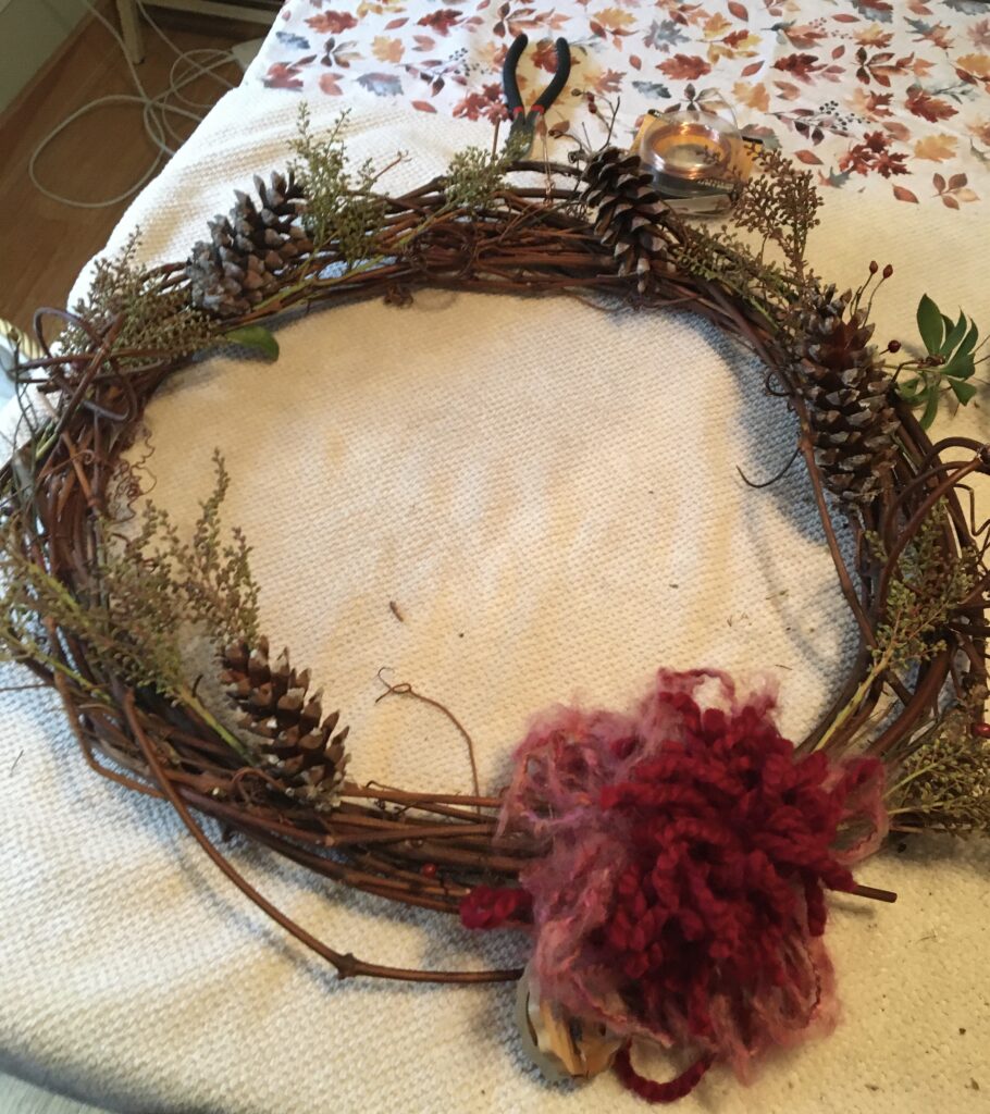 decorated wreath with naturals materials and floppy yarn bow