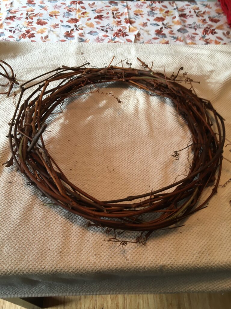 grape vine made into a wreath shape held in place by wire