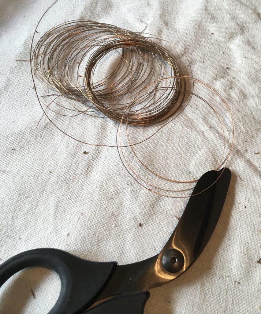 fine copper wire with scissors