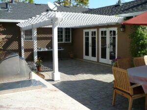 A patio with an awning and a pergola