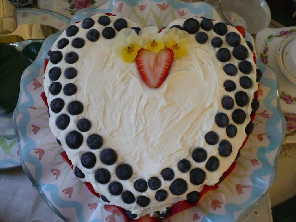 Cake decorated with fruit and flowers