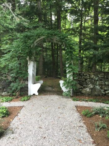 bench arch leading out to the forest