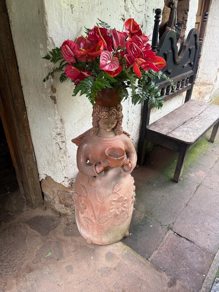 Lady with flowers vase in El Salvador