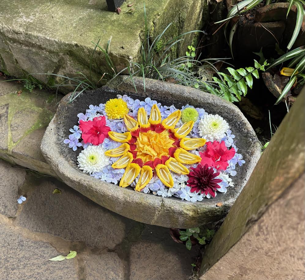 Flowers floating in a grinding bowl in El Salvador