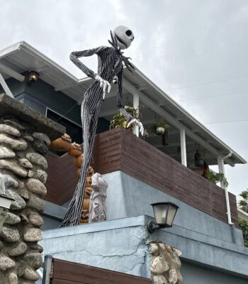 Halloween skeleton in danger of falling on the sidewalk