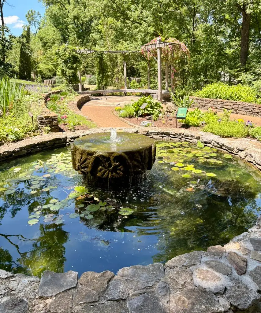 Mill stone Fountain at Cheekwood with garden